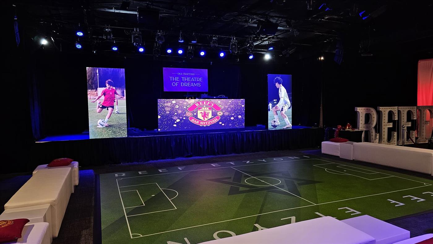 Moving-head fixtures rigged overhead at a corporate event